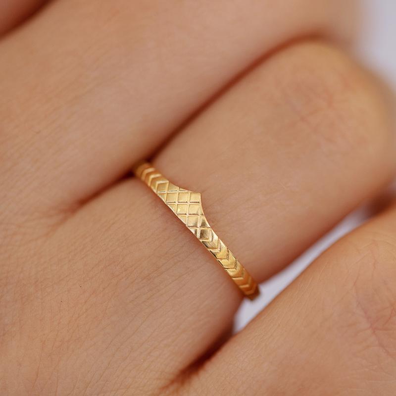 delicate wedding band patterned ring on hand